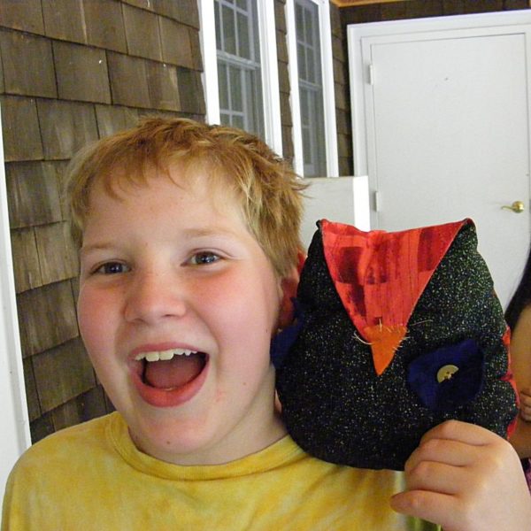 happy boy with an owl he sewed himself