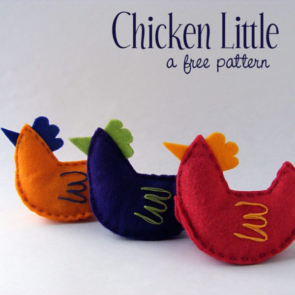 A row of three colorful felt chickens made with a free hand sewing pattern from Shiny Happy World