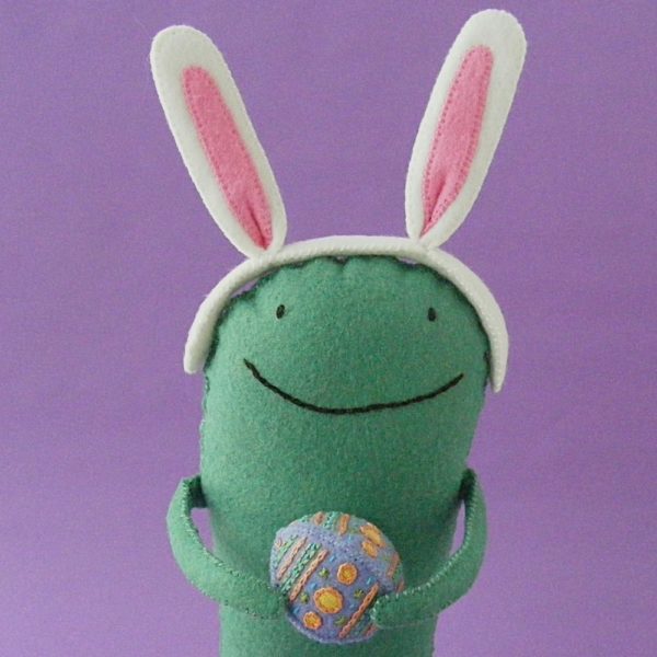 green felt monster (made from the Oddballs pattern) wearing bunny ears made with the free Easter Eggstras pattern from Shiny Happy World 