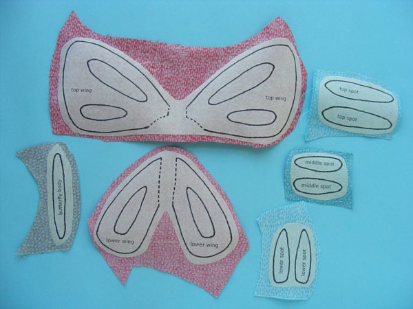 butterfly applique pattern pieces fused to the back side of the fabric