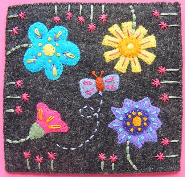 Finished felt coaster made with a free pattern from Shiny Happy World