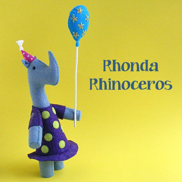 Rhonda Rhinoceros - a cute felt softie of a rhino wearing a polkadot dress and holding a balloon