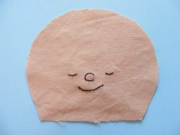 embroidered doll face