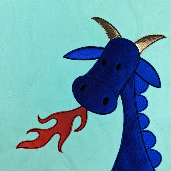 Satin applique used to make a shiny blue dragon quilt block