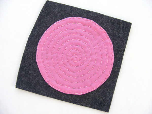 Making Polkadot Felt Coasters - stitching a pink circle down to grey felt using running stitch