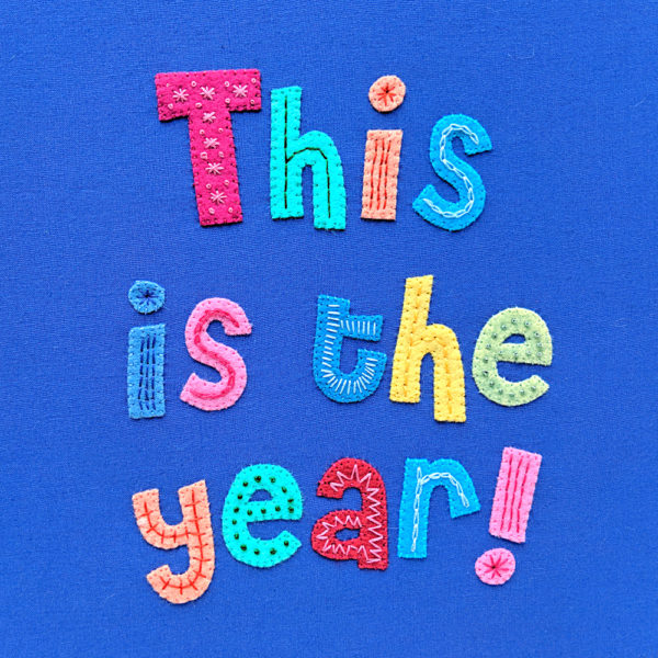 applique felt and embroidered letters saying, "This is the year!"