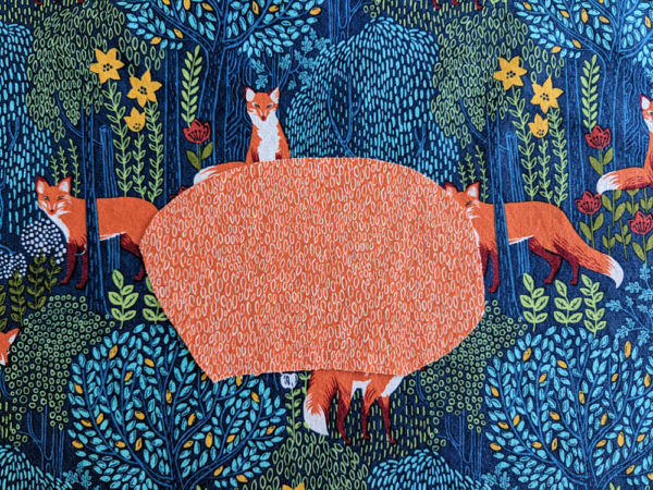 orange oval on multicolored fox print fabric - demonstrating how like colors blend into one shape when they touch