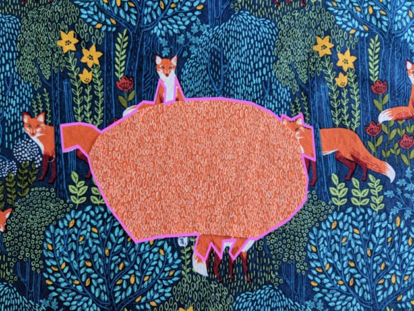 orange oval on multicolored fox print fabric - demonstrating how like colors blend into one shape when they touch by outlining the new shape formed