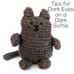 dark brown crochet cat with black eyes