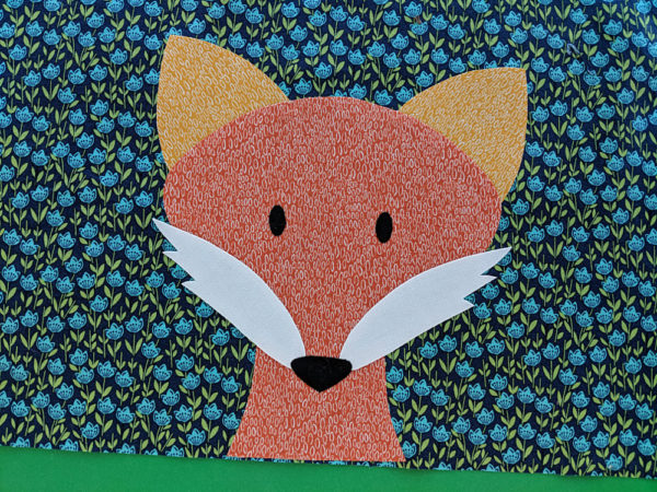 applique fox face added to the corner of a receiving blanket pattern