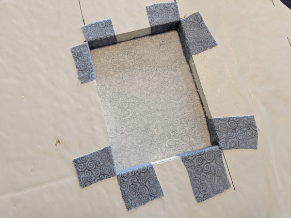 outlet hole with corners covered with grey fabric