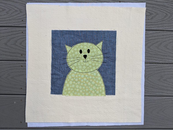 cat face and shoulders - appliqued to grey background square