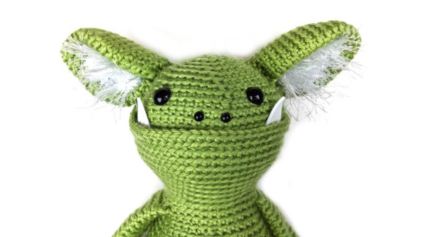 green crocheted monster head with hairy ears