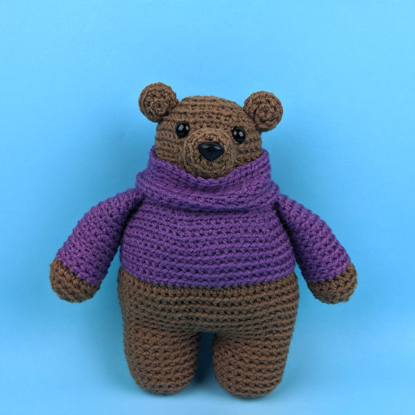 Byron Bear - a crocheted bear wearing a purple turtleneck sweater, made with a pattern from Shiny Happy World