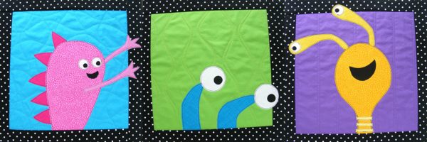 set of three blocks - each showing a monster made with applique, busting out of its frame