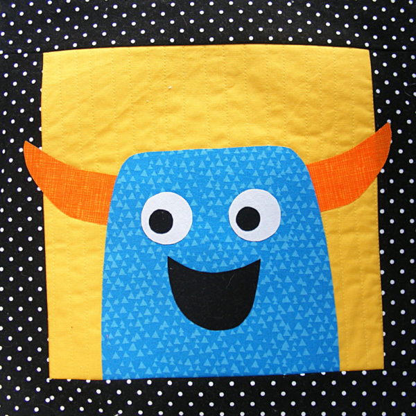 blue monster with orange horns, showing how to make applique bust out of its frame