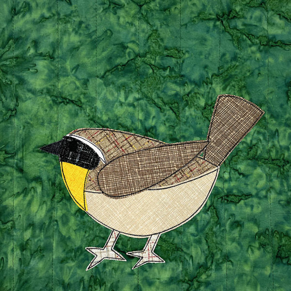 Applique of a yellowthroat - demonstrating how to choose fabric for a realistic bird