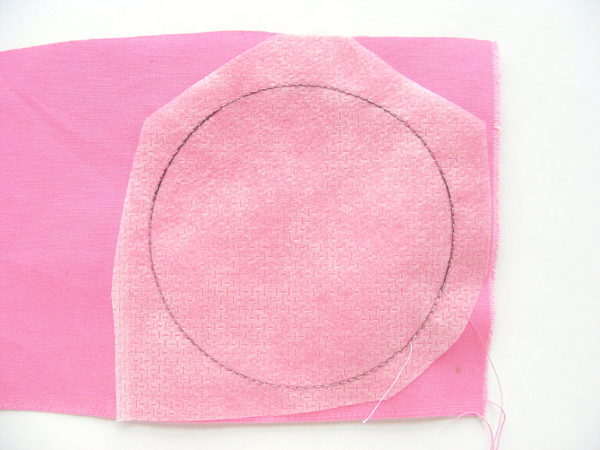 making coasters - circle sewn on stabilizer with pink fabric