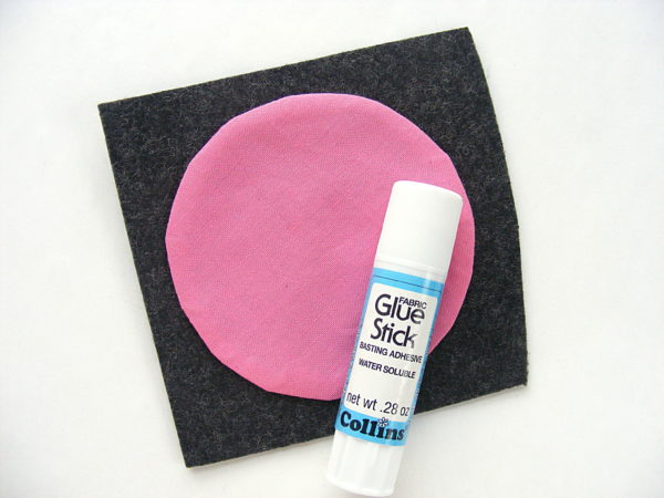 Making Felt Coasters - pink fabric circle glued to a square of grey felt.