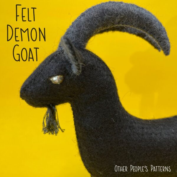 Felt Goat - Black Phillip from the movie The Witch, made with black felt and gold rhinestone eyes.