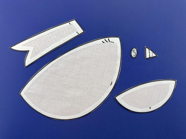 Bird applique pieces with window-cut fusible adhesive applied to the back.