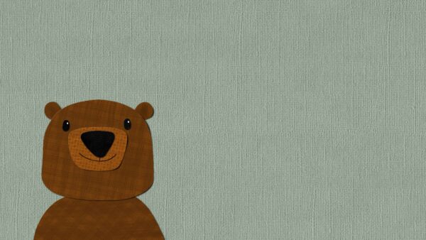 Cute teddy bear with a friendly face, made of patterned fabric, on a textured green background.