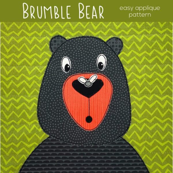 Cute black bear applique with a fly on his nose nose on green zigzag background.