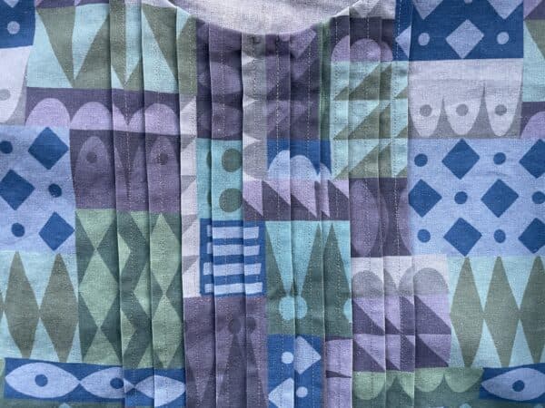 Close-up of colorful geometric patterned fabric for a pintuck dress.