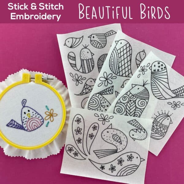 Bird embroidery kit with black and white bird patterns and a colorful embroidered bird.